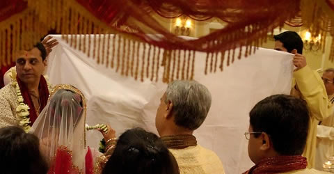 In Gujarati marriage, Antarpat is the ceremony where a curtain is placed and lowered between the groom and bride.